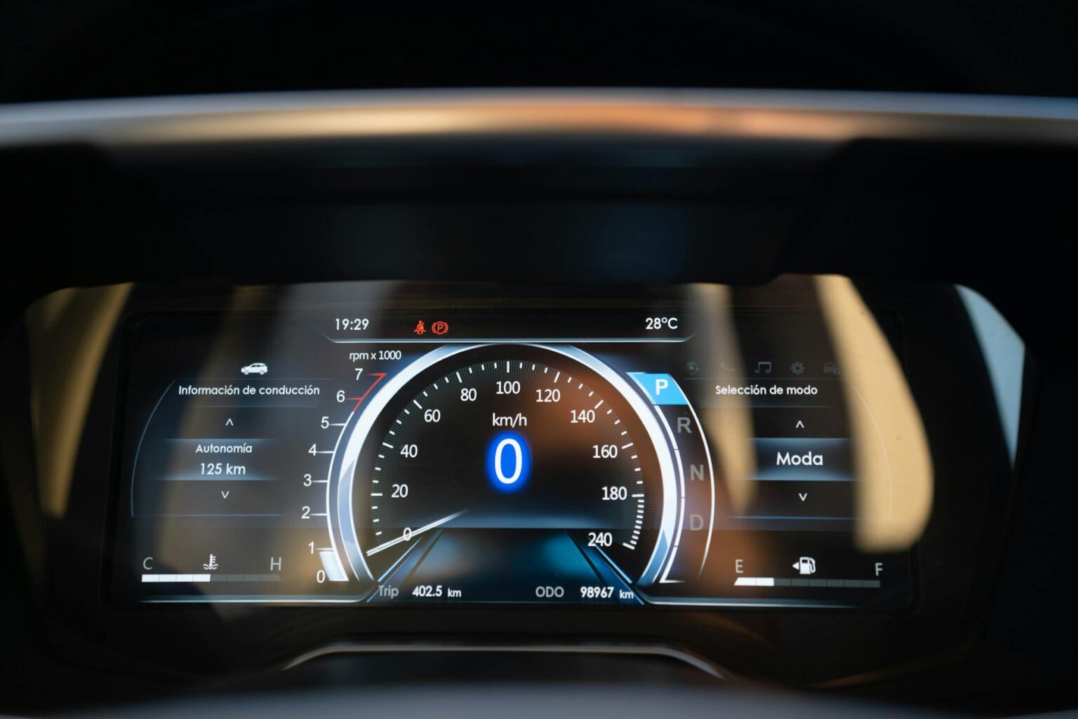Modern car dashboard with digital displays and diagnostic port connector