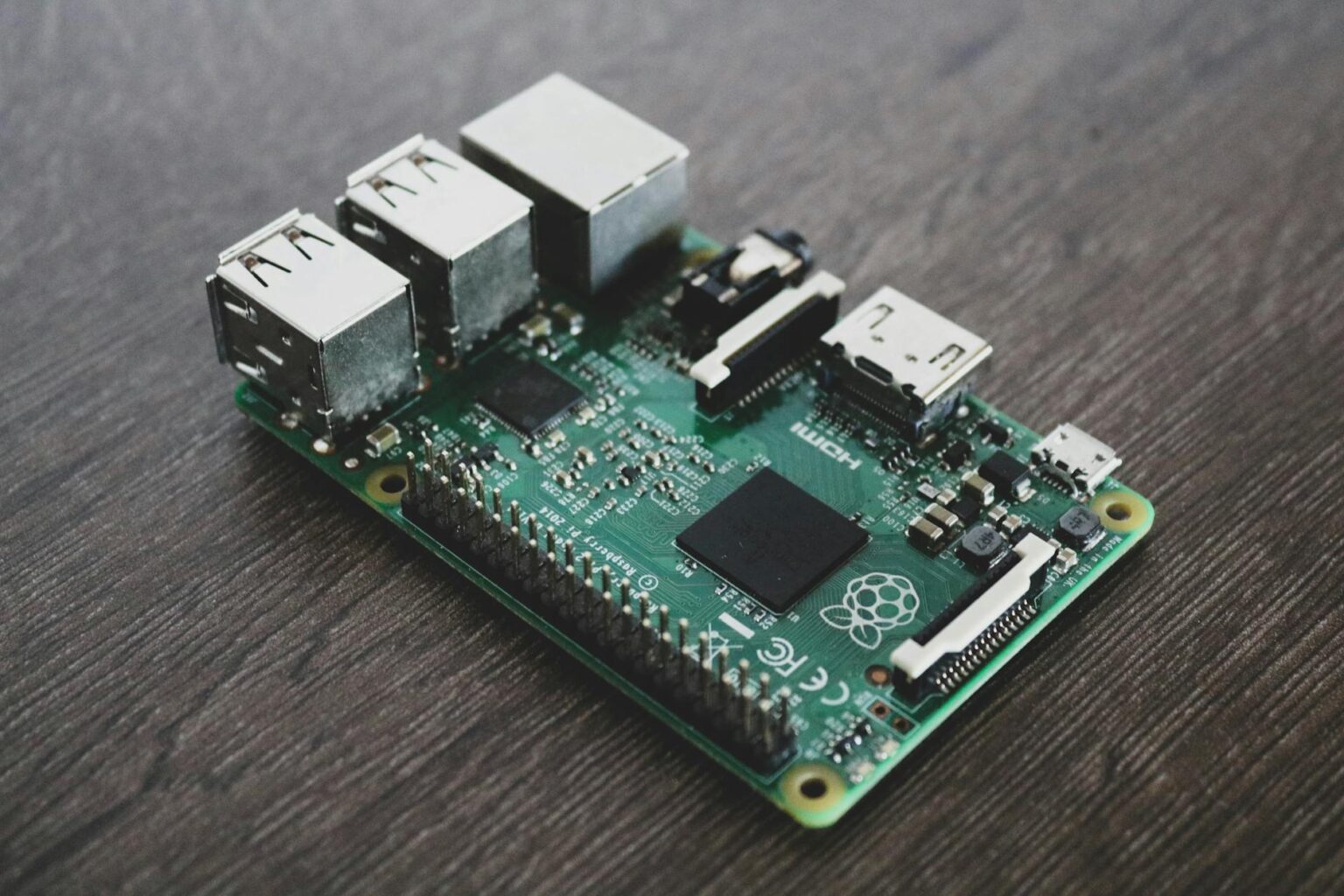 Raspberry Pi single board computer with connected cables and components on white background