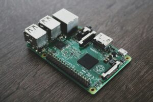 Raspberry Pi single board computer with connected cables and components on white background
