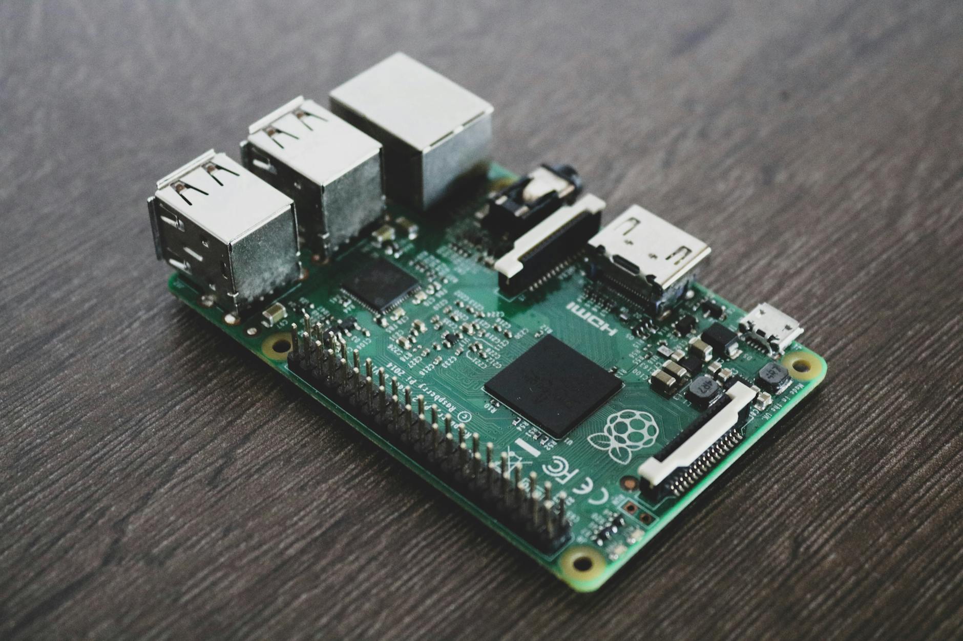 Raspberry Pi single board computer with connected cables and components on white background