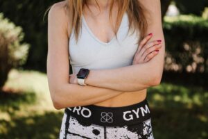 Person wearing smartwatch while exercising, showing fitness tracking display