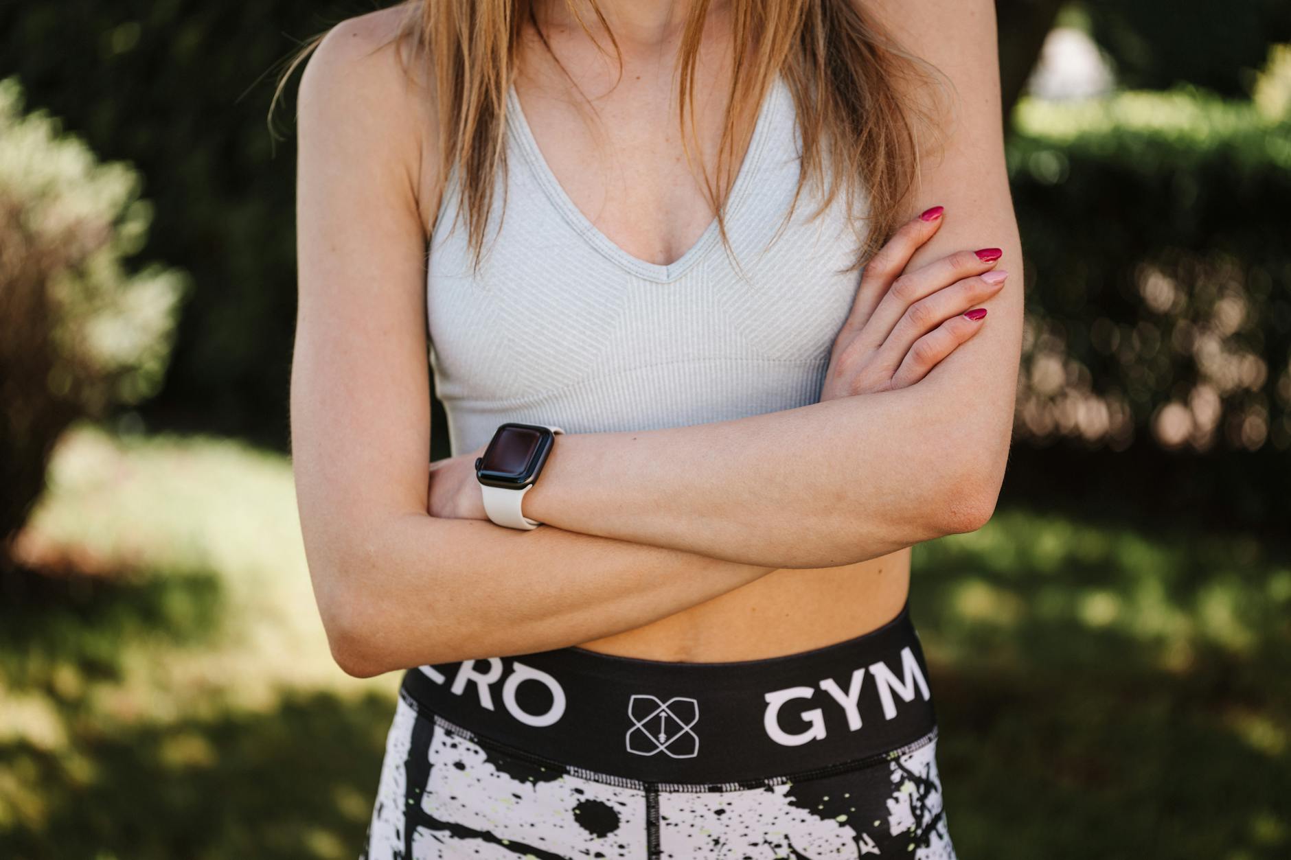 Person wearing smartwatch while exercising, showing fitness tracking display