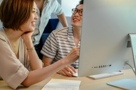 People collaborating on computers in modern office workspace