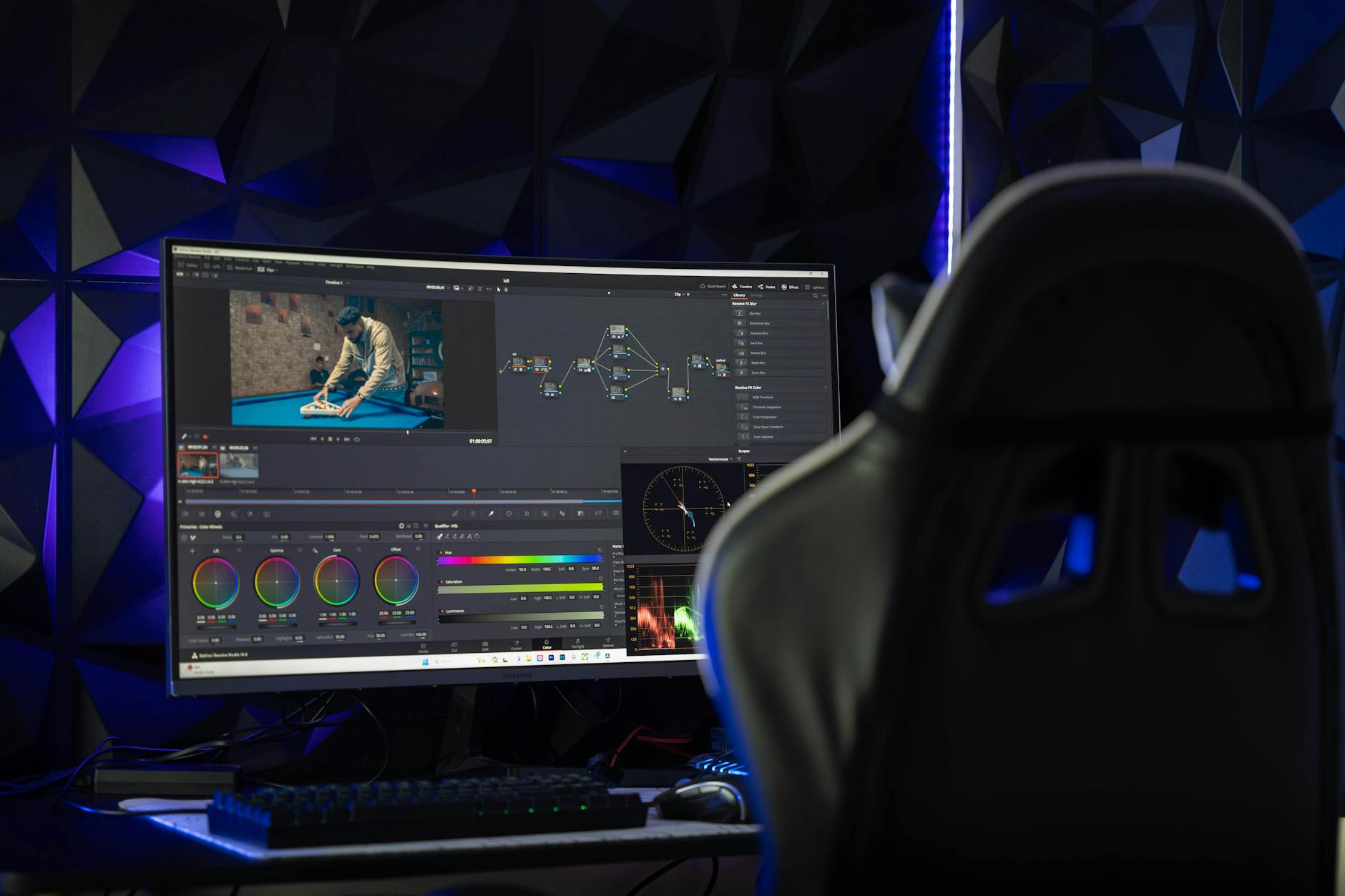 Professional video editing workspace displaying multiple monitors with editing software interface