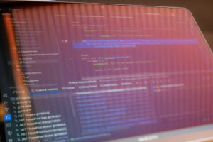 Developer working on code with multiple monitors showing programming interfaces