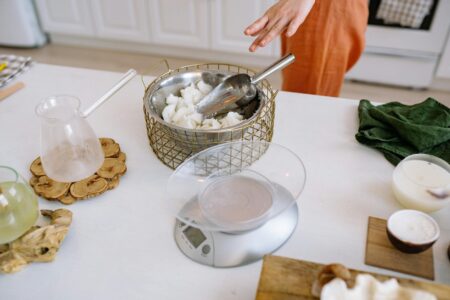 Modern digital kitchen scale with smartphone app displaying nutritional information