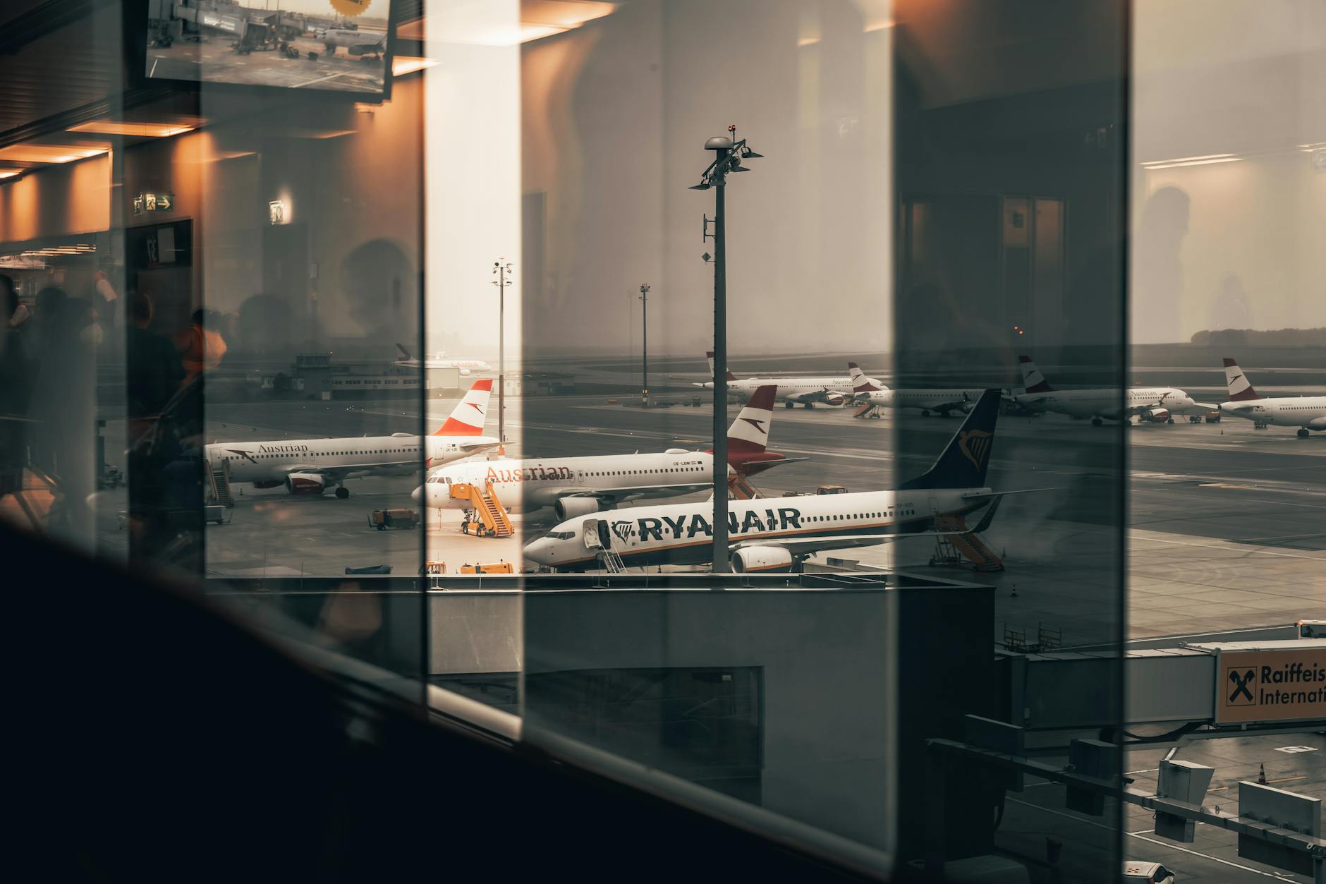Business professional working on laptop in airport terminal waiting area
