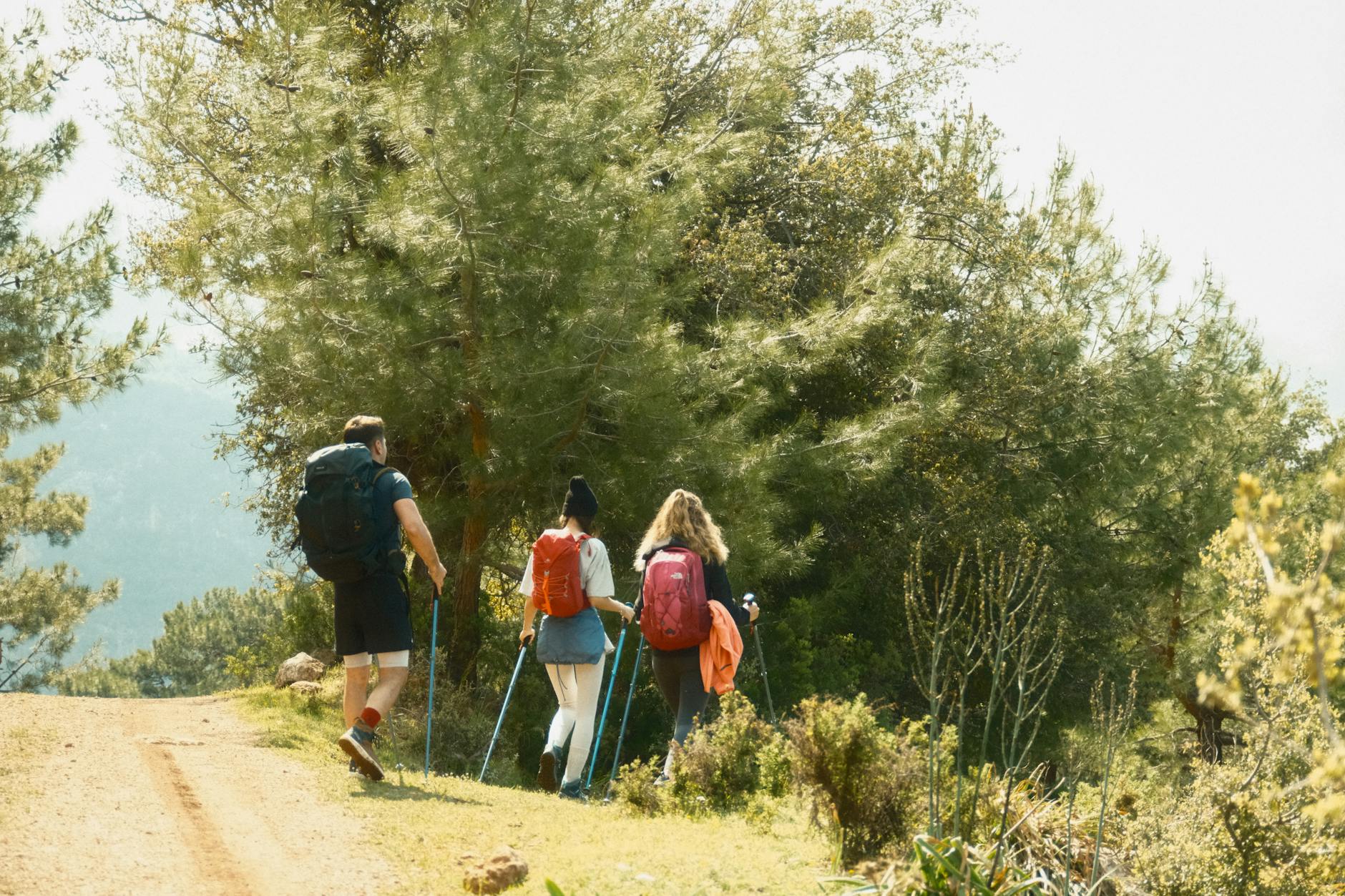 Hiker with backpack on mountain trail showcasing outdoor gear needs