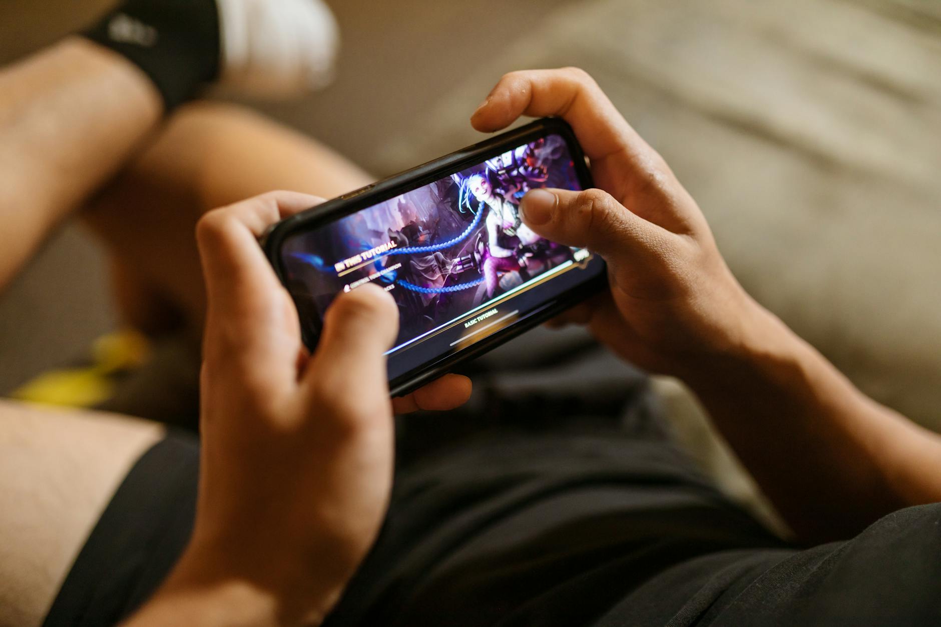 Person playing mobile games on smartphone showing performance capabilities of modern Android phones