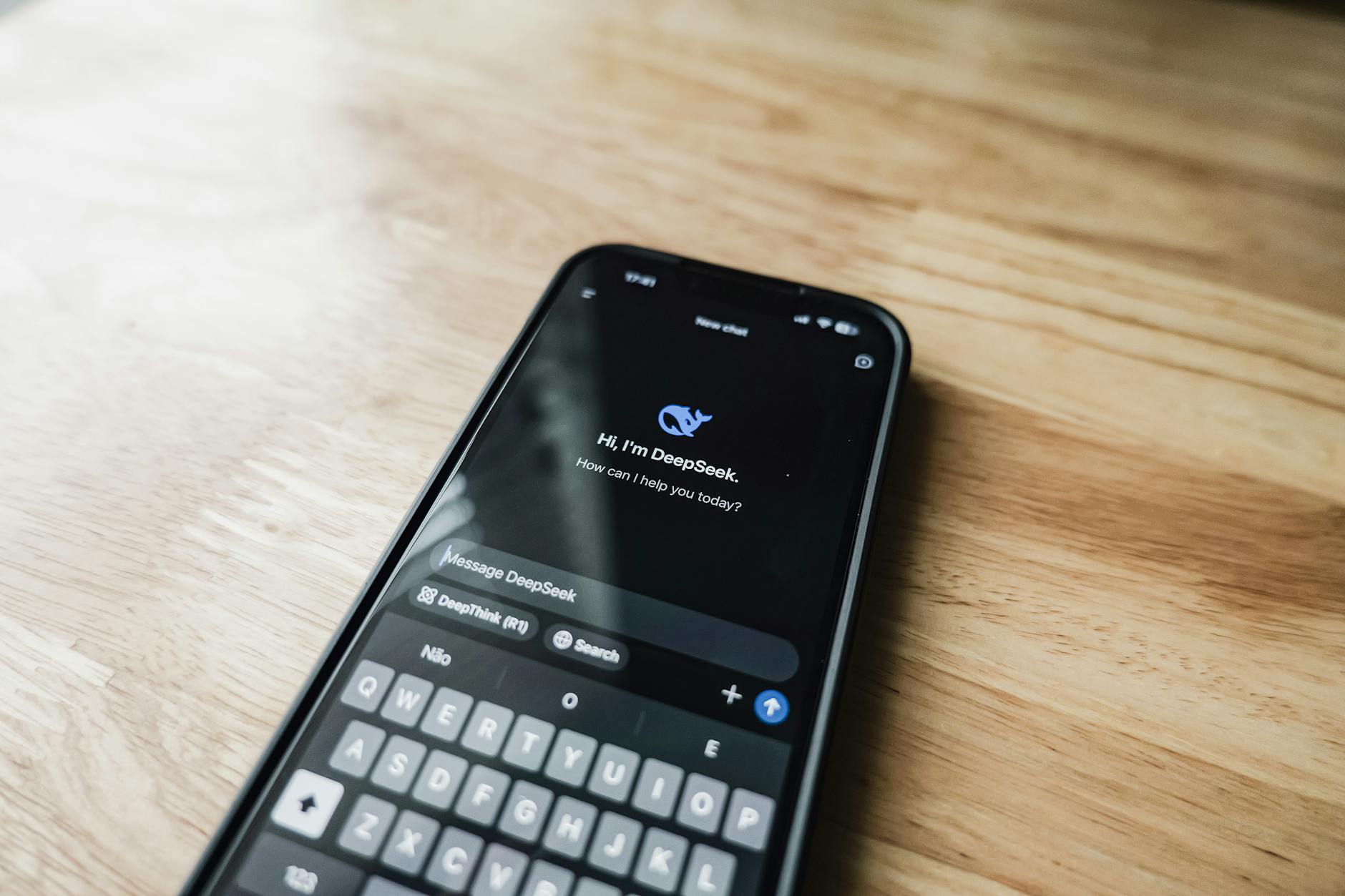 Hand holding smartphone displaying mobile app settings interface