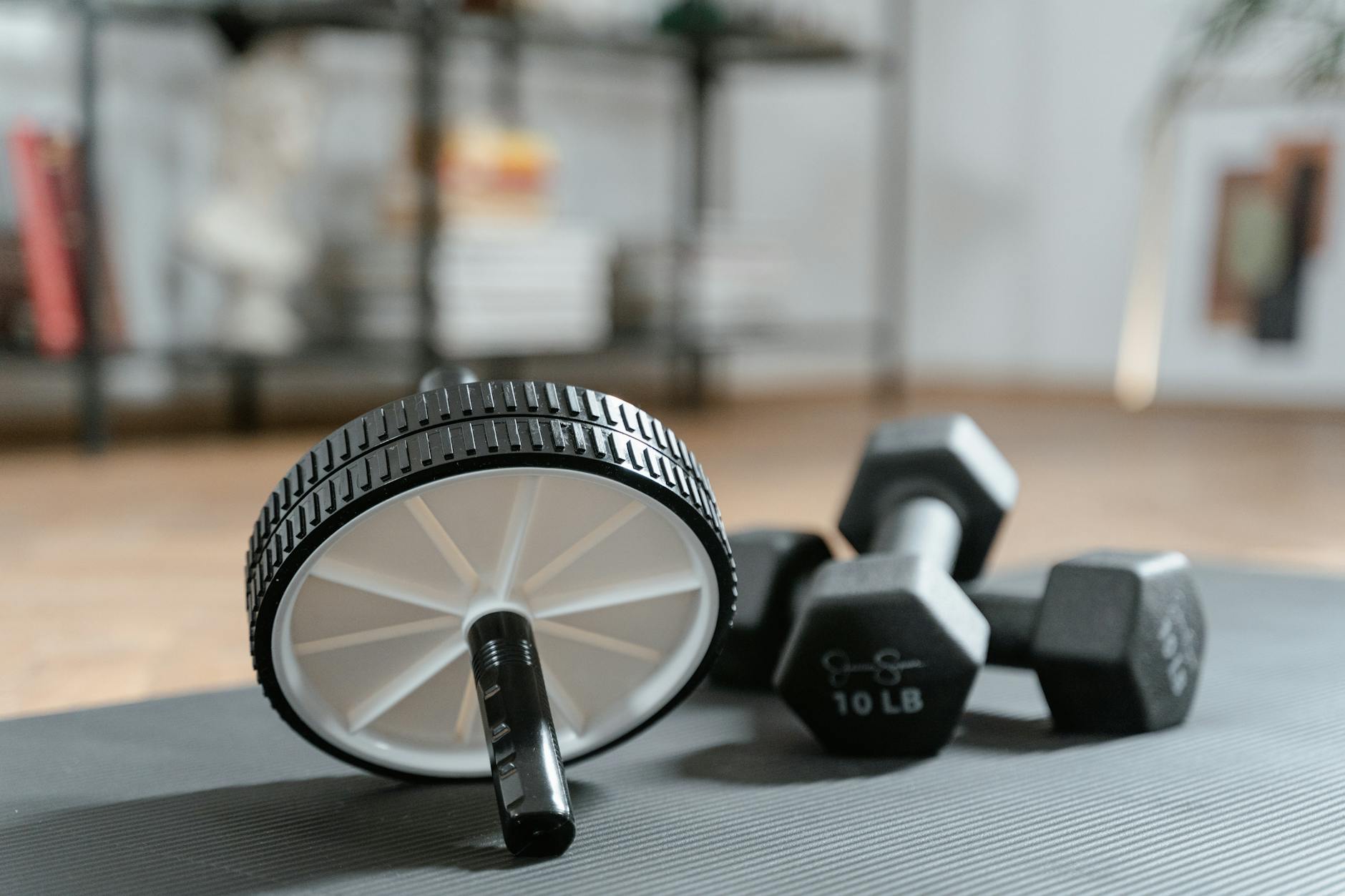 Contemporary home gym setup with exercise equipment and wall-mounted display screen