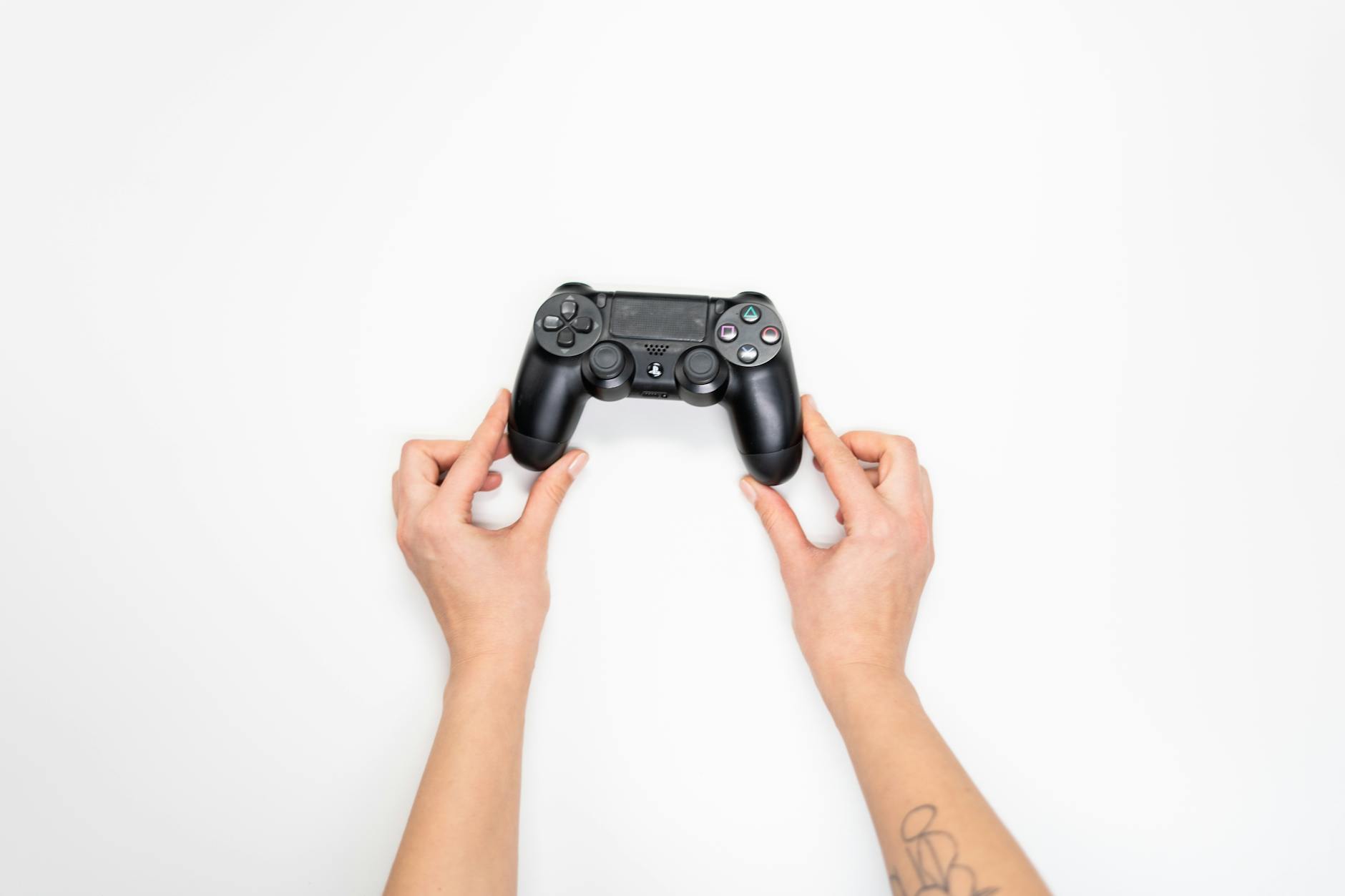 Person holding gaming controller while playing video games