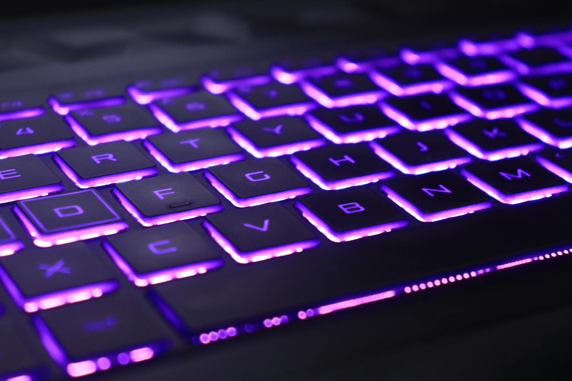 Gaming keyboard with colorful RGB backlighting in dark room