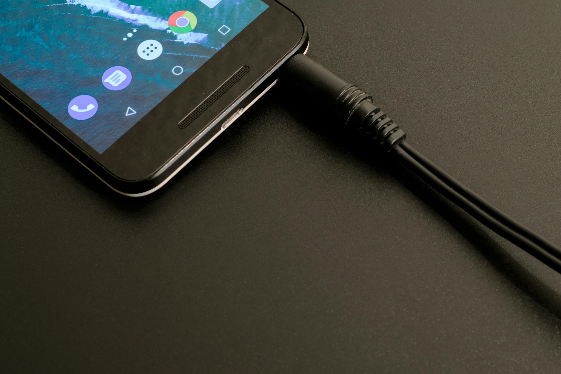 USB-C charging cable connected to smartphone for power delivery
