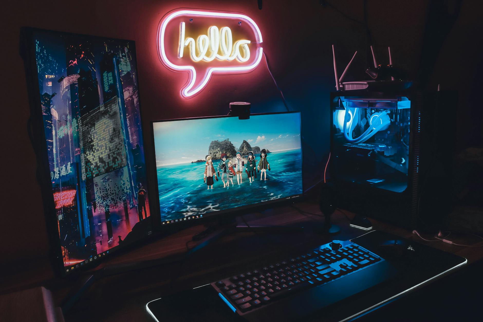 Modern gaming computer setup with RGB lighting and multiple monitors displaying high-resolution games