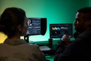 Professional video editing setup with monitor displaying color grading interface