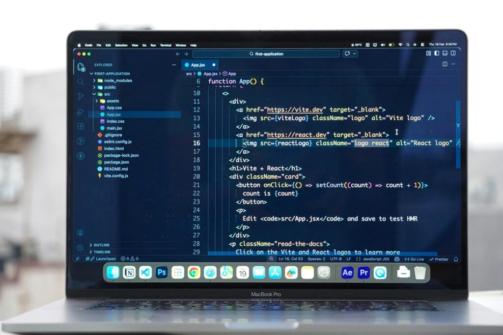 Close-up of laptop screen showing code and database interface for Notion formula development