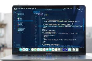 Close-up of laptop screen showing code and database interface for Notion formula development