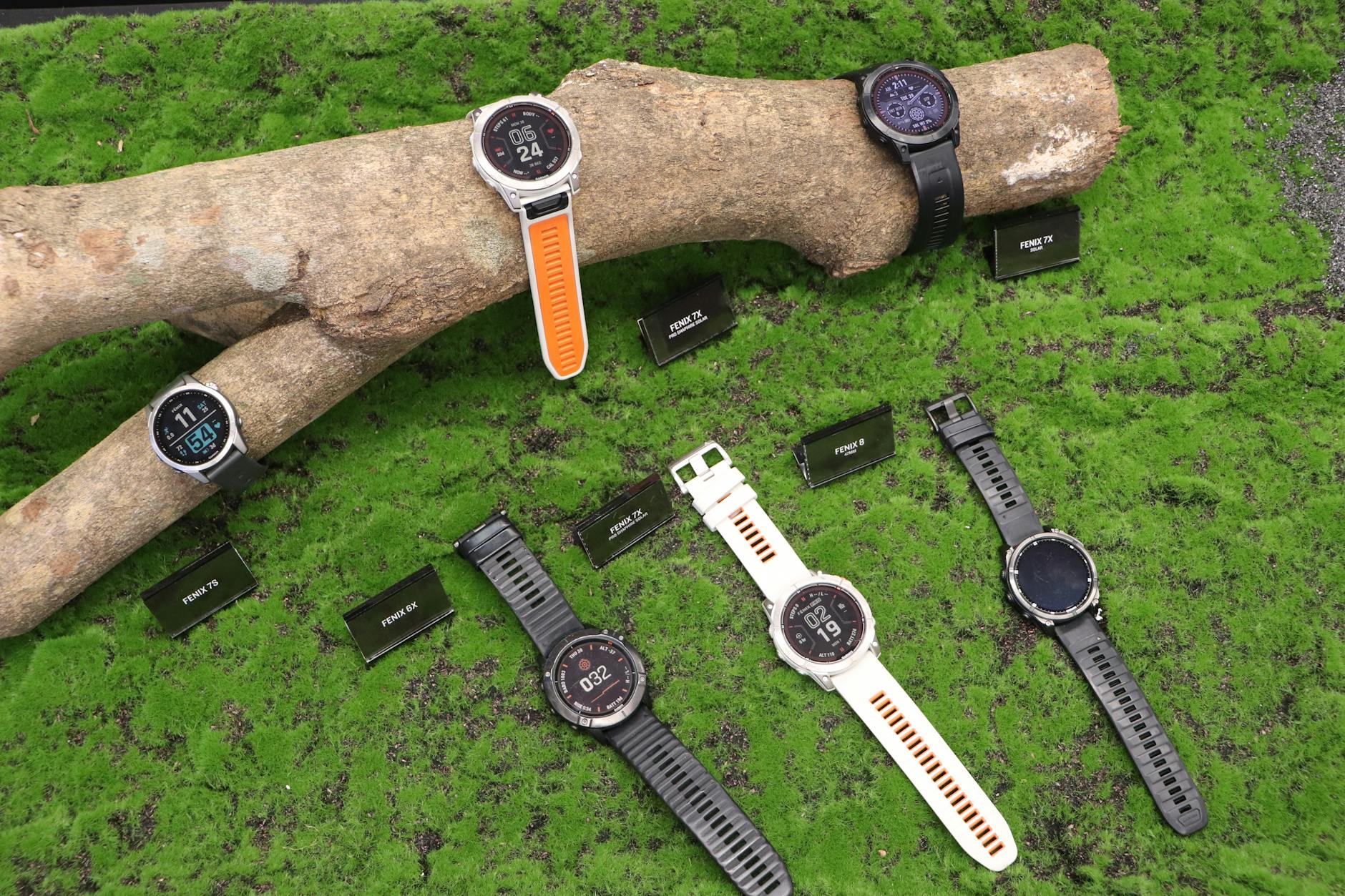 Two rugged smartwatches side by side on a rocky outdoor surface