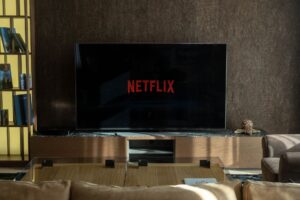 A modern living room home theater setup with a large TV and soundbar on a media console
