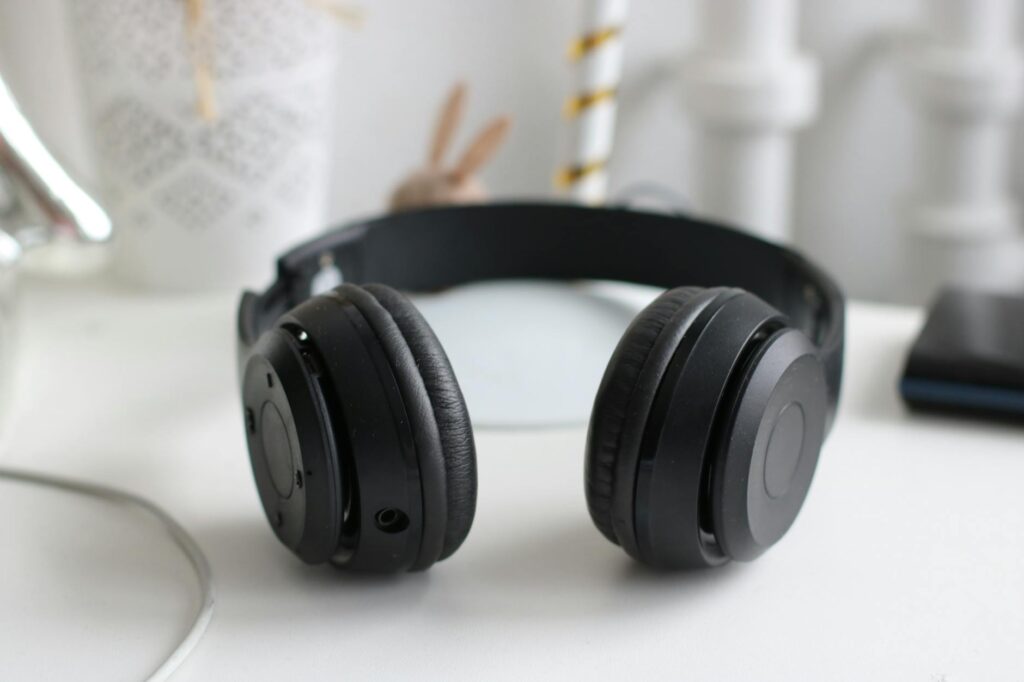 Sony WH-1000XM6 vs Bose QuietComfort Ultra: Best ANC Headphones Premium over-ear wireless headphones resting on a desk surface