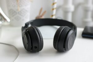 Premium over-ear wireless headphones resting on a desk surface