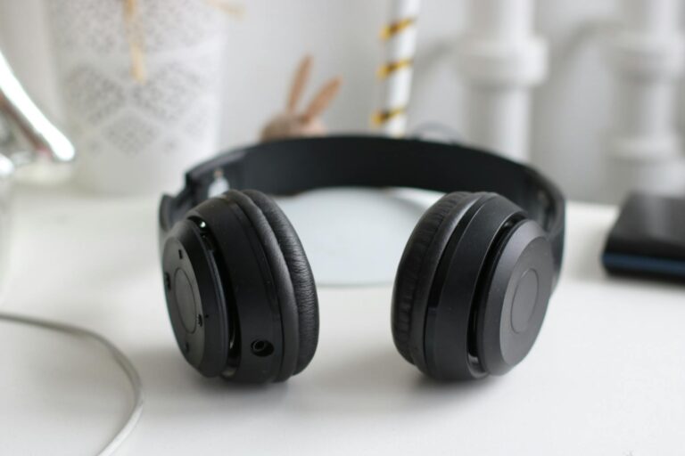 Sony WH-1000XM6 vs Bose QuietComfort Ultra: Best ANC Headphones Premium over-ear wireless headphones resting on a desk surface