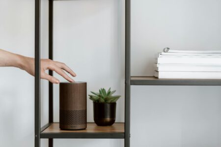 Sonos Era 300 vs KEF LSX II: Best Wireless Bookshelf Speakers A pair of compact wireless bookshelf speakers on a wooden shelf in a modern living room