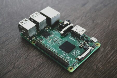 Raspberry Pi single-board computer connected to a network cable on a desk