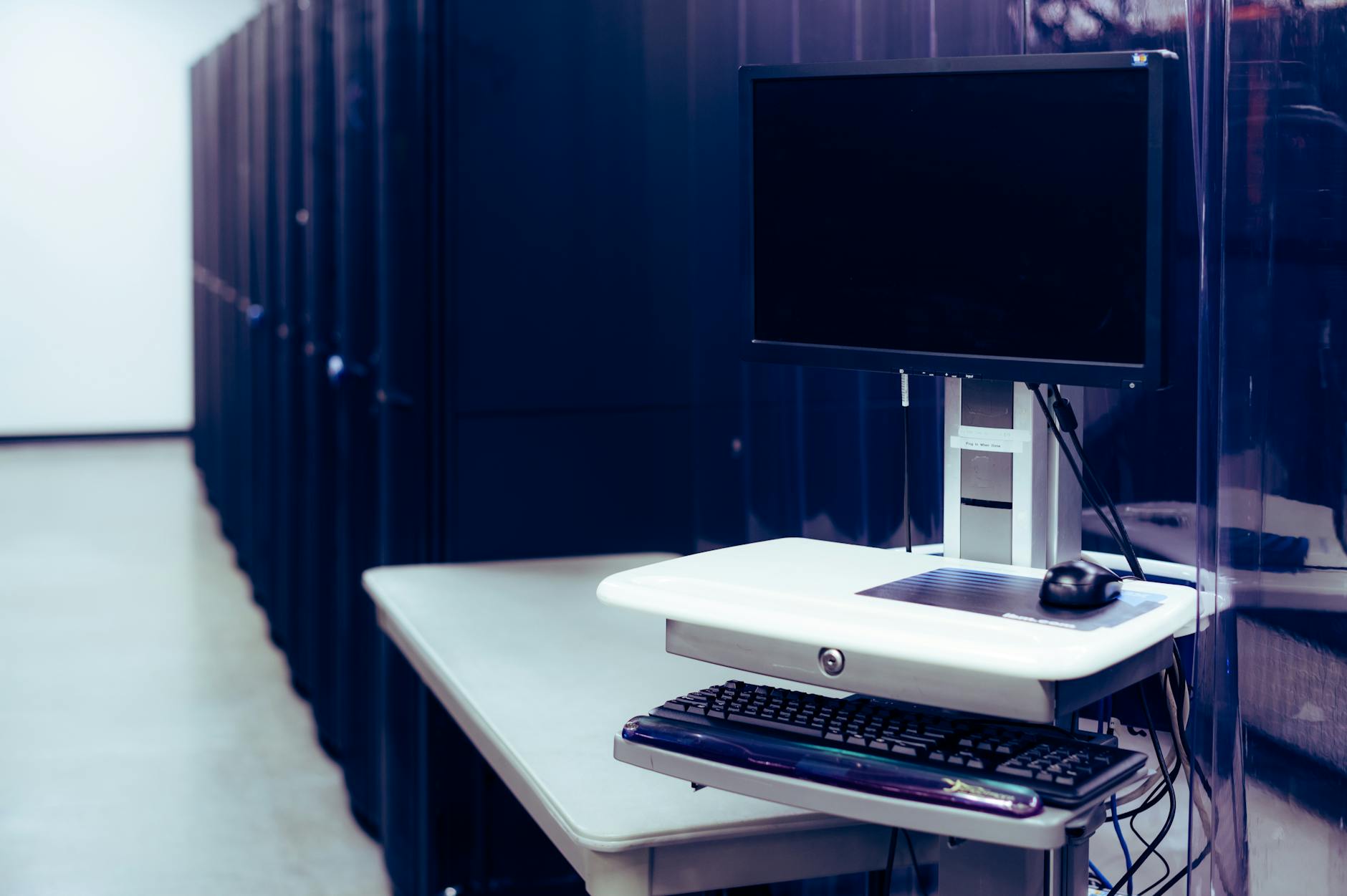 Modern server rack in datacenter with networking equipment and cables