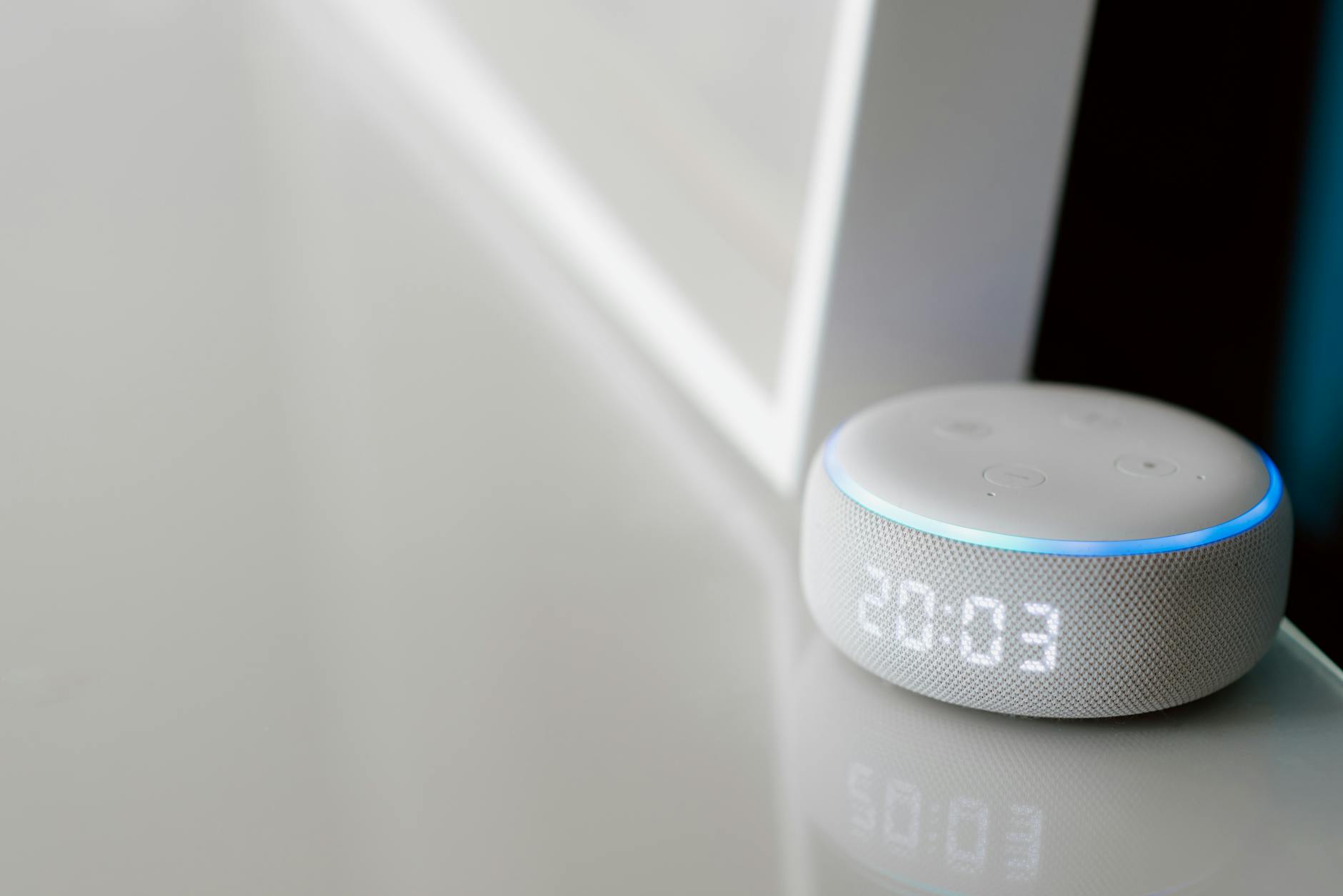 Modern smart home devices and control panel setup on wooden desk
