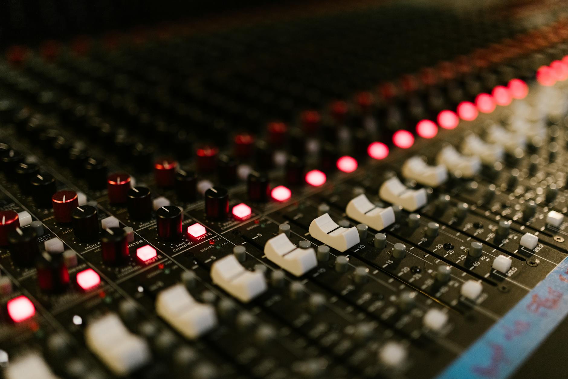 Professional audio mixing board with faders and controls for sound engineering