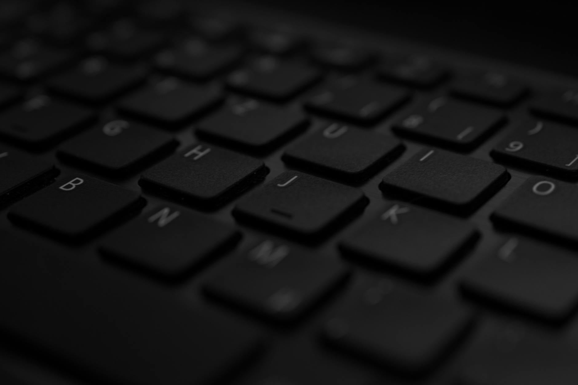 Close-up view of hands typing on a mechanical keyboard