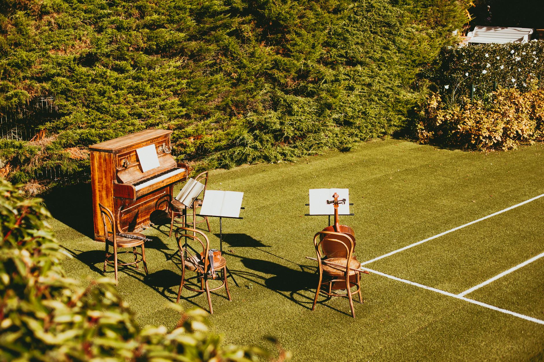 Group of people gathered at an outdoor backyard party with music playing
