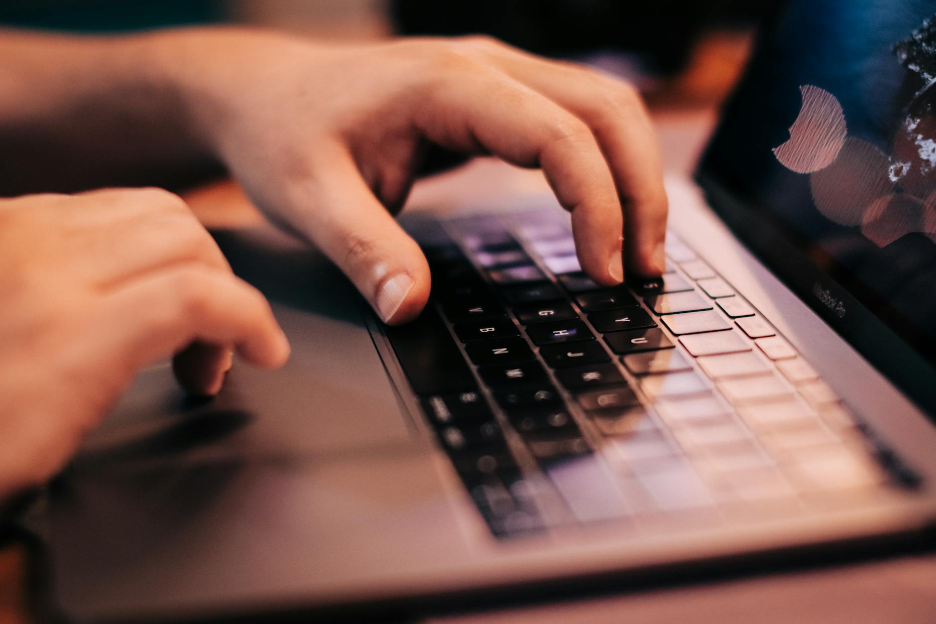 Person working on laptop computer with terminal window open showing command line interface