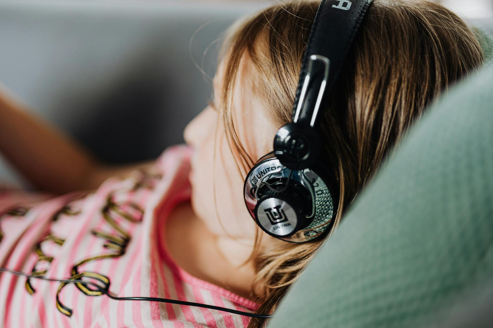 Close-up of over-ear headphones being worn by a listener