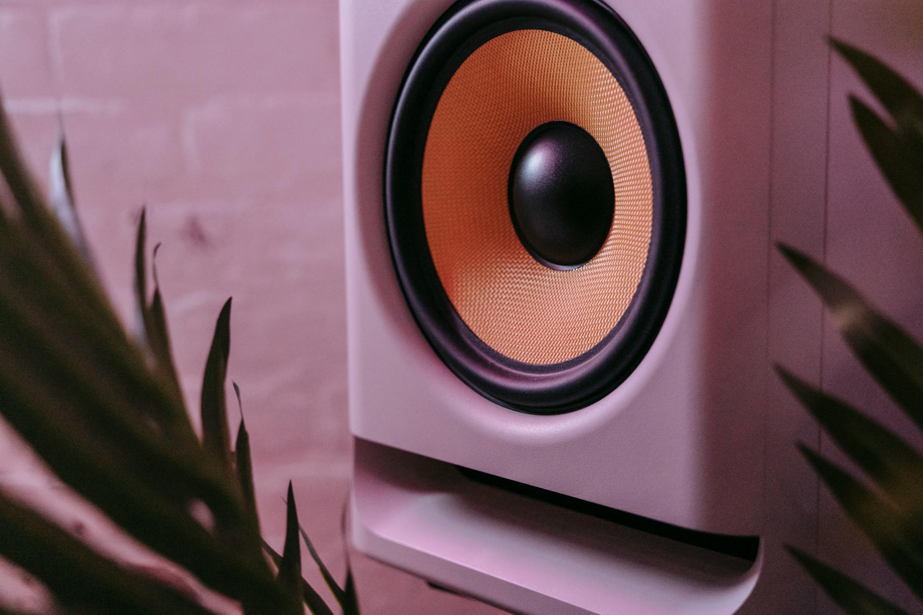 Close-up of a speaker with visible sound wave visualization in a dark setting
