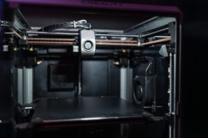 Bambu Lab A1 Mini vs Prusa MINI+: Best Budget 3D Printer A compact desktop 3D printer producing a small object on its print bed