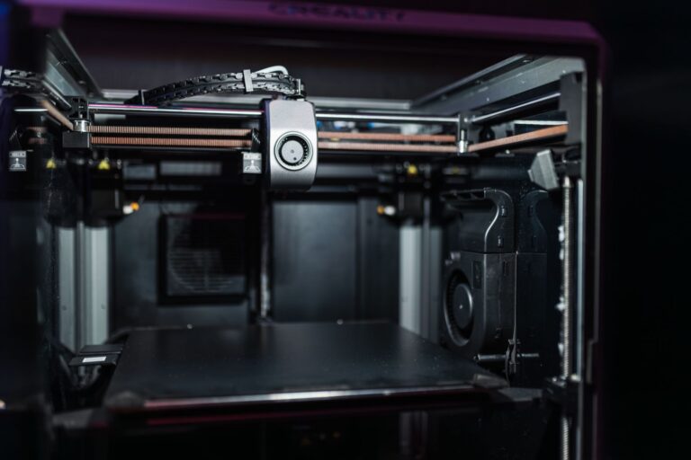 Bambu Lab A1 Mini vs Prusa MINI+: Best Budget 3D Printer A compact desktop 3D printer producing a small object on its print bed