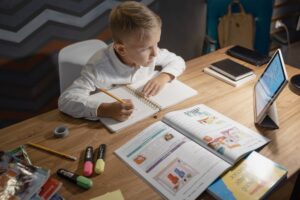 Remarkable Paper Pro 2 vs Supernote A5X2: Best Digital Notebook Person writing on a digital e-ink tablet at a clean desk workspace