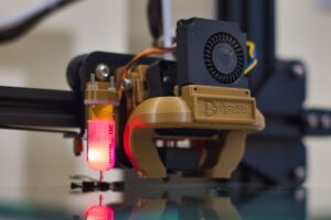 Bambu Lab A1 vs Creality Ender 3 V3: Best Beginner 3D Printer A modern desktop 3D printer producing a detailed plastic model on a build plate