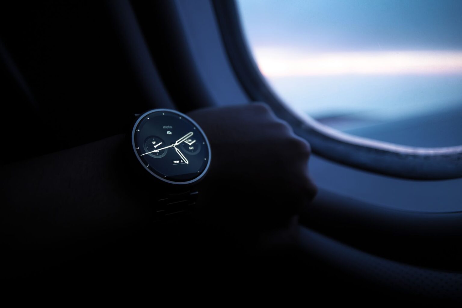 Close-up of a rugged smartwatch with titanium case on a rocky outdoor surface