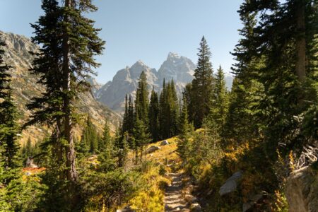 Hiker on a remote mountain trail where satellite communication would be essential