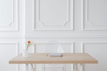 Clean minimal home office desk setup with a monitor showing a web browser
