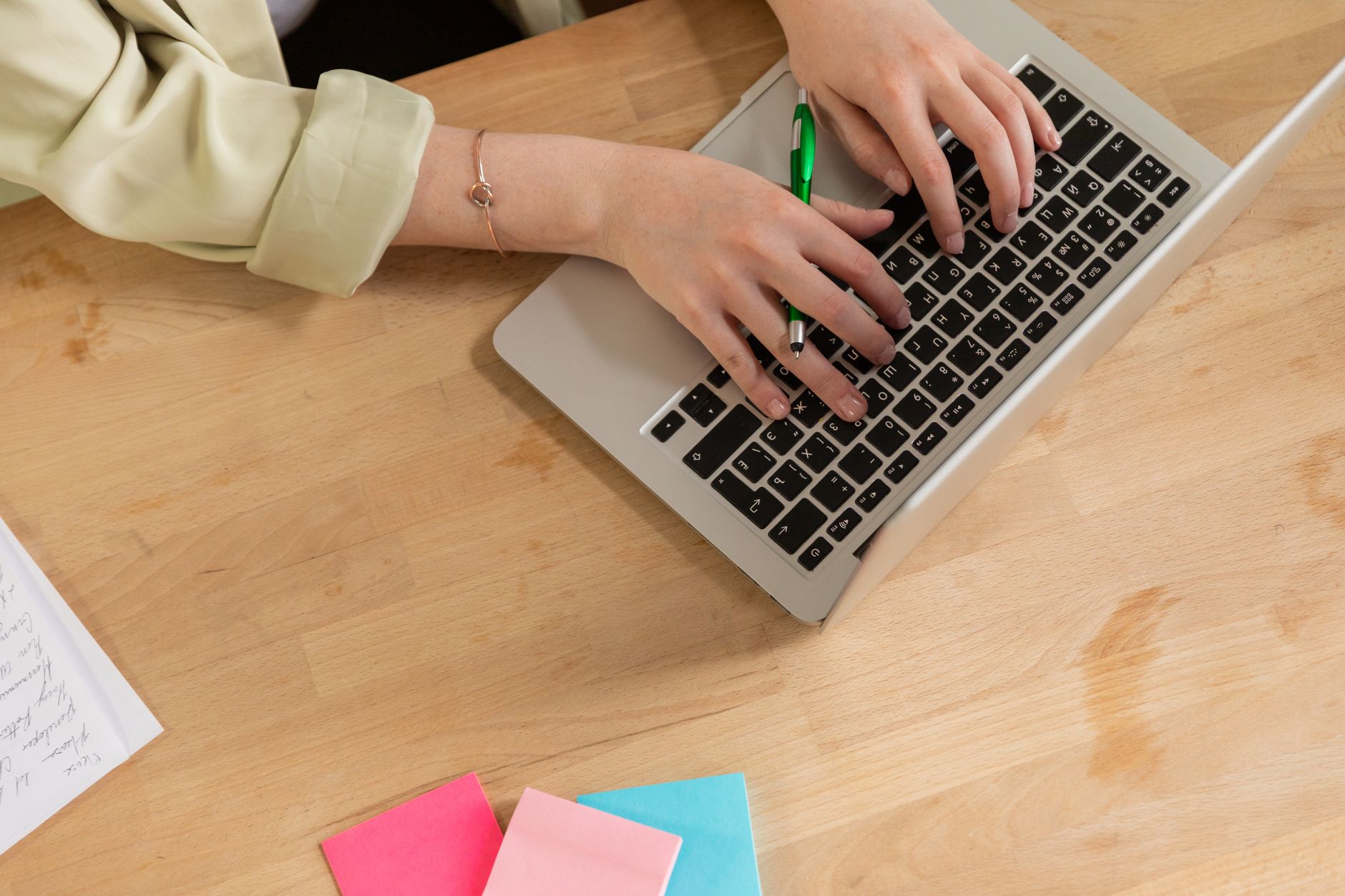 Laptop open on a desk with notes visible on screen, representing Obsidian note-taking setup