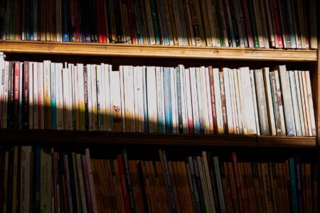 A shelf of organized comic books representing a personal comic library collection