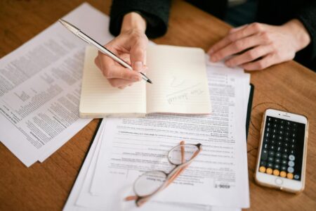 Tax documents and calculator on a desk representing sales tax compliance