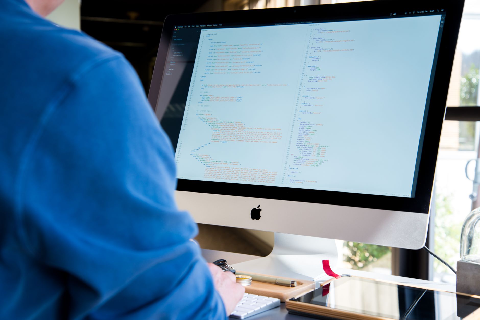 Developer working on project management software at a desktop computer