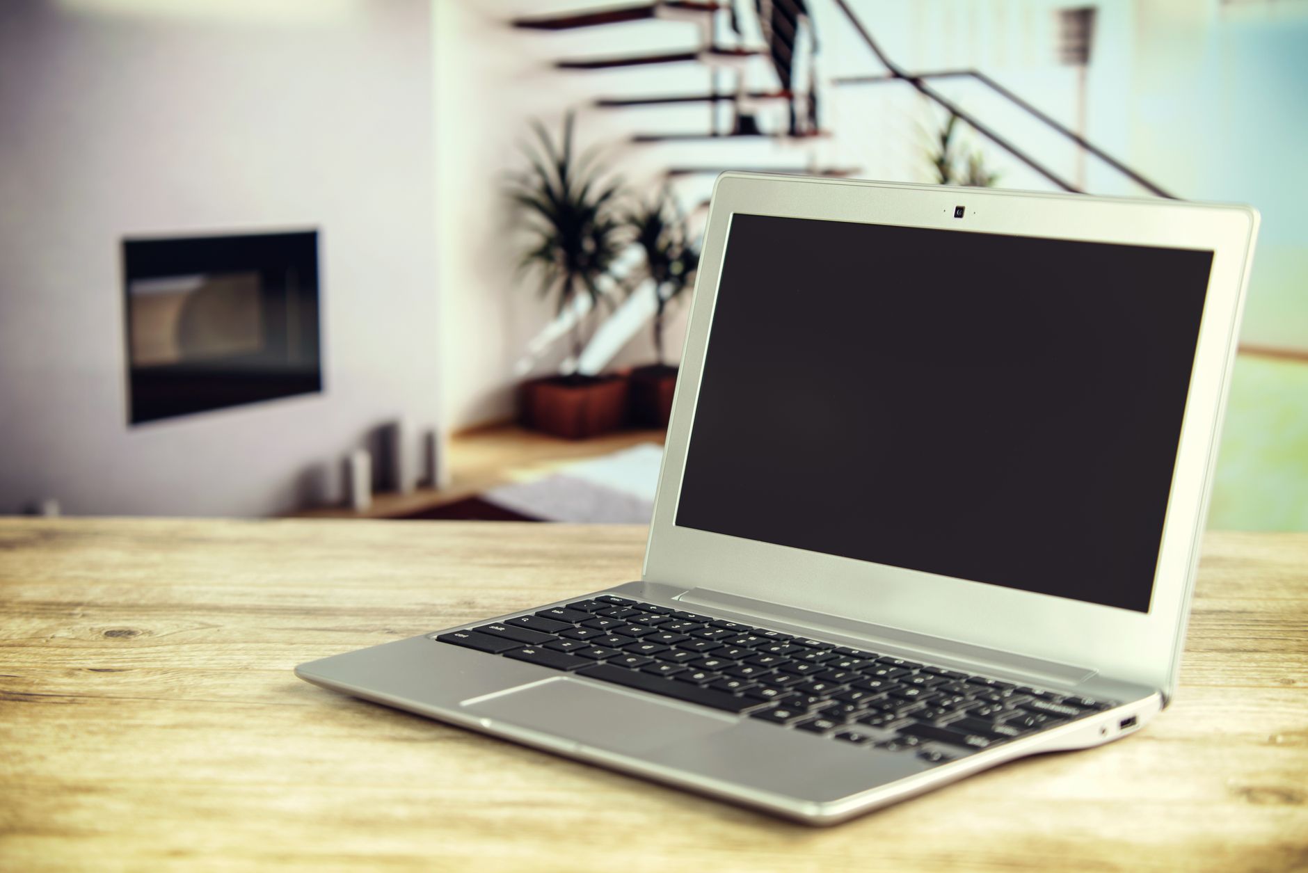 A laptop displaying a web application interface on a home desk, representing a self-hosted server setup
