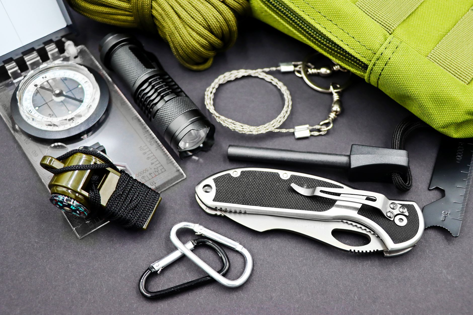 Outdoor survival and navigation gear laid out for a backcountry expedition